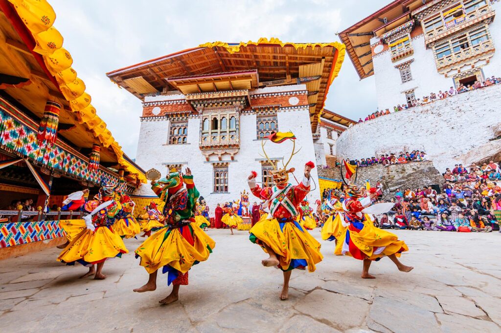 dance performers in a traditional mask in costume at the gasa festival