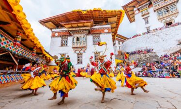 dance performers in a traditional mask in costume at the gasa festival