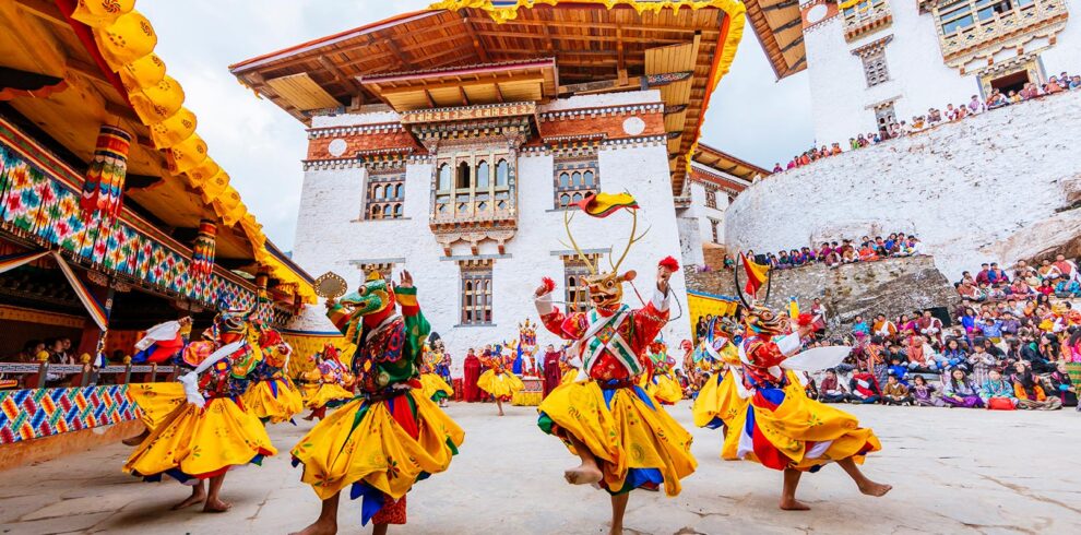 dance performers in a traditional mask in costume at the gasa festival