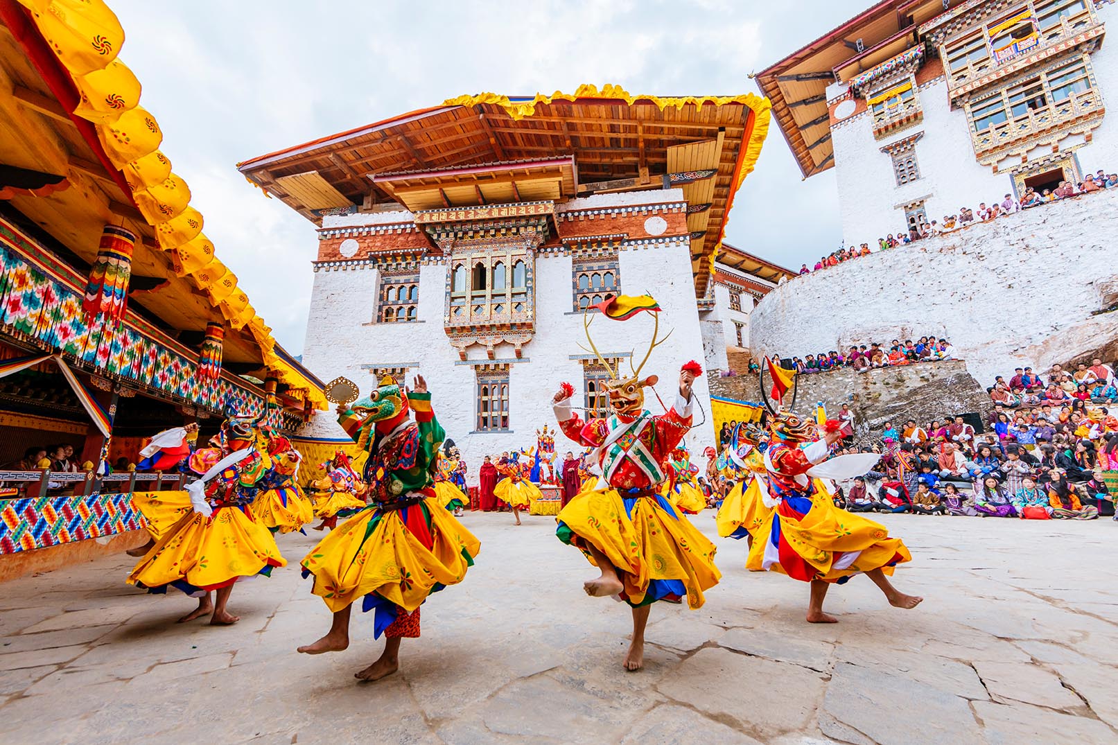 dance performers in a traditional mask in costume at the gasa festival
