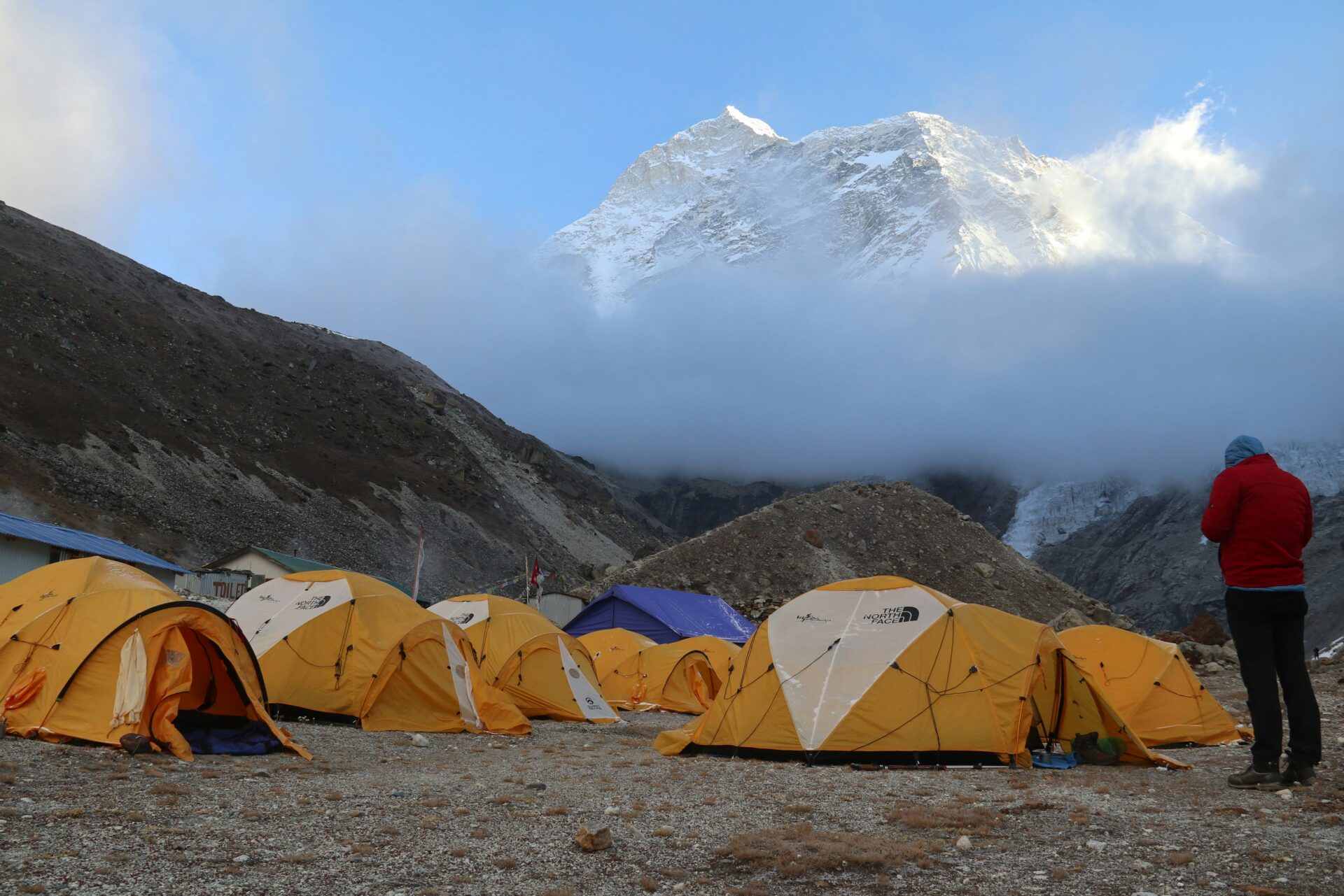 A trekking camp with tents beneath a Himalayan peak in Bhutan