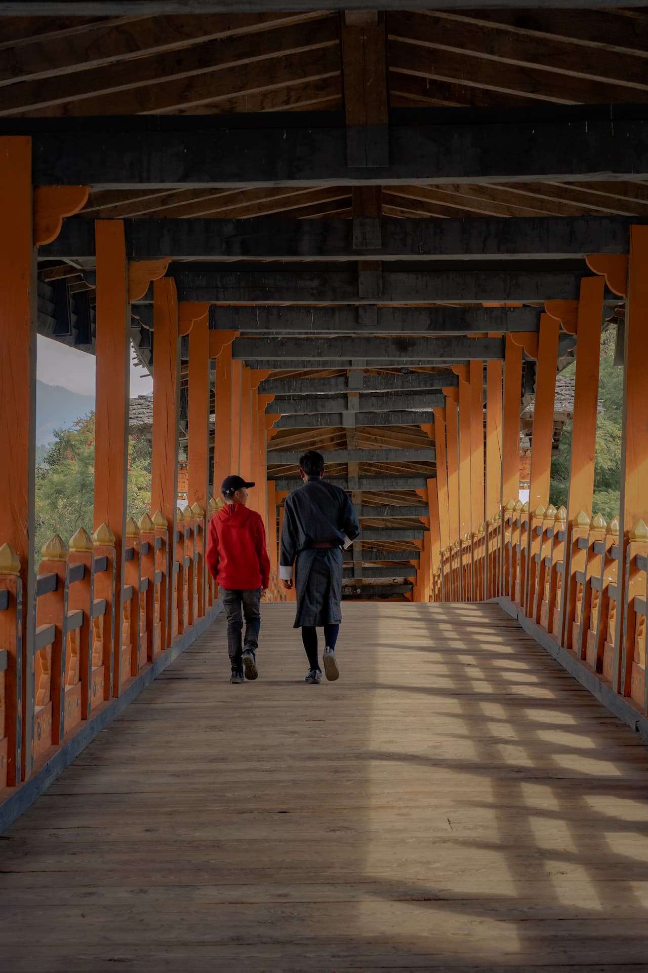 Traditional wooden bridge leading to the entrance of Punakha Dzong, Bhutan