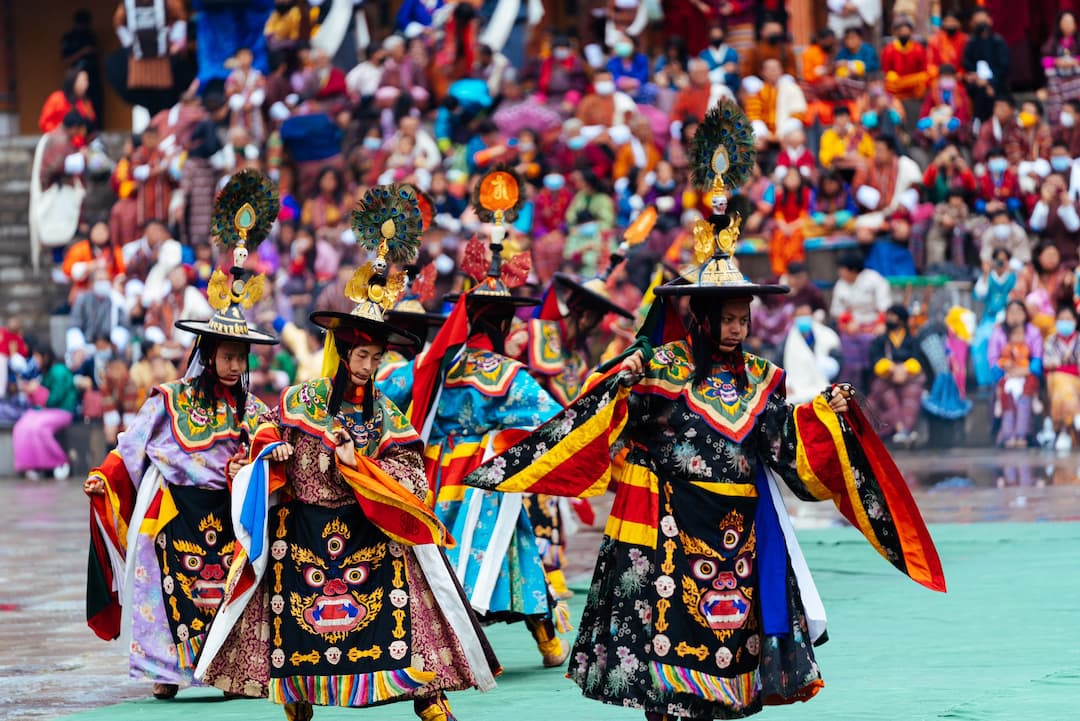 Masked cham dancers at a Bhutanese tshechu