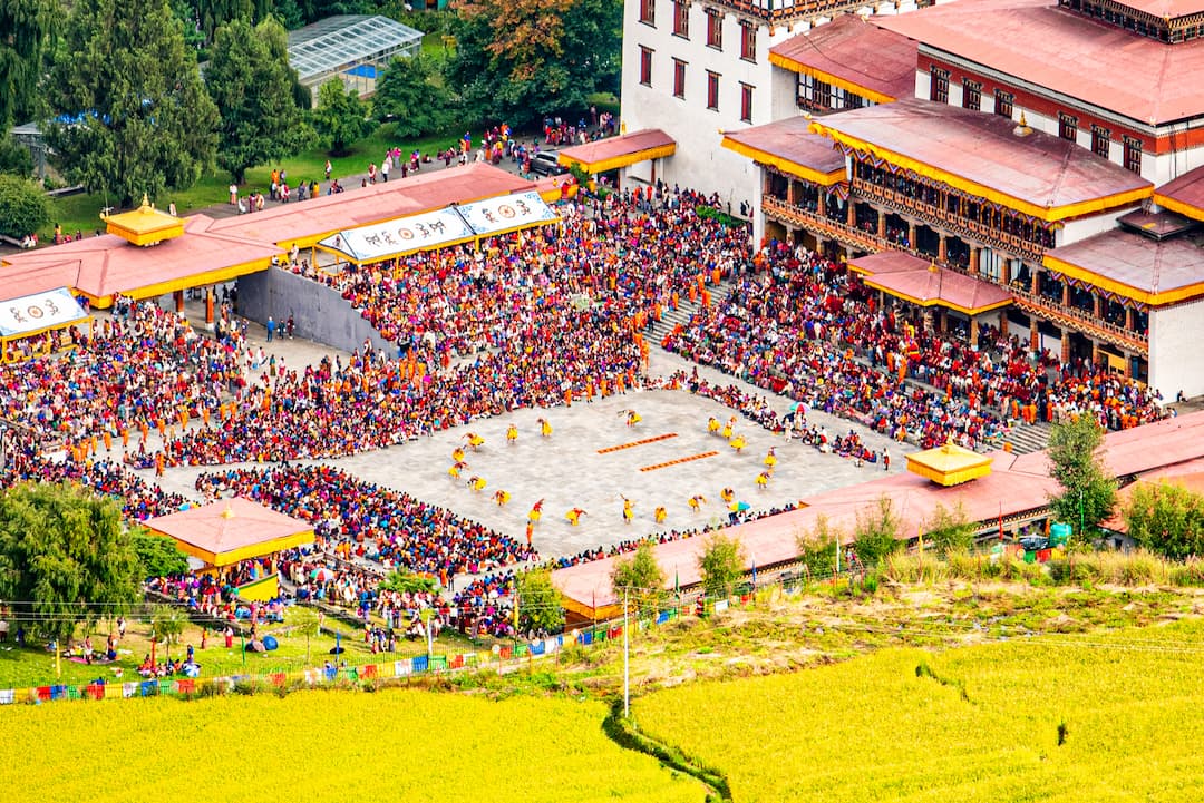 Aerial view of a dzong courtyard during a tshechu
