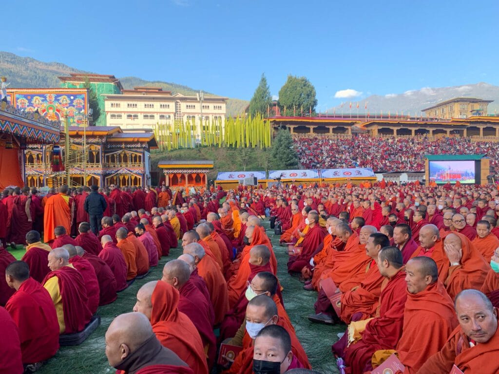 Monk giving a Buddhist dharma talk to a small group in Bhutan